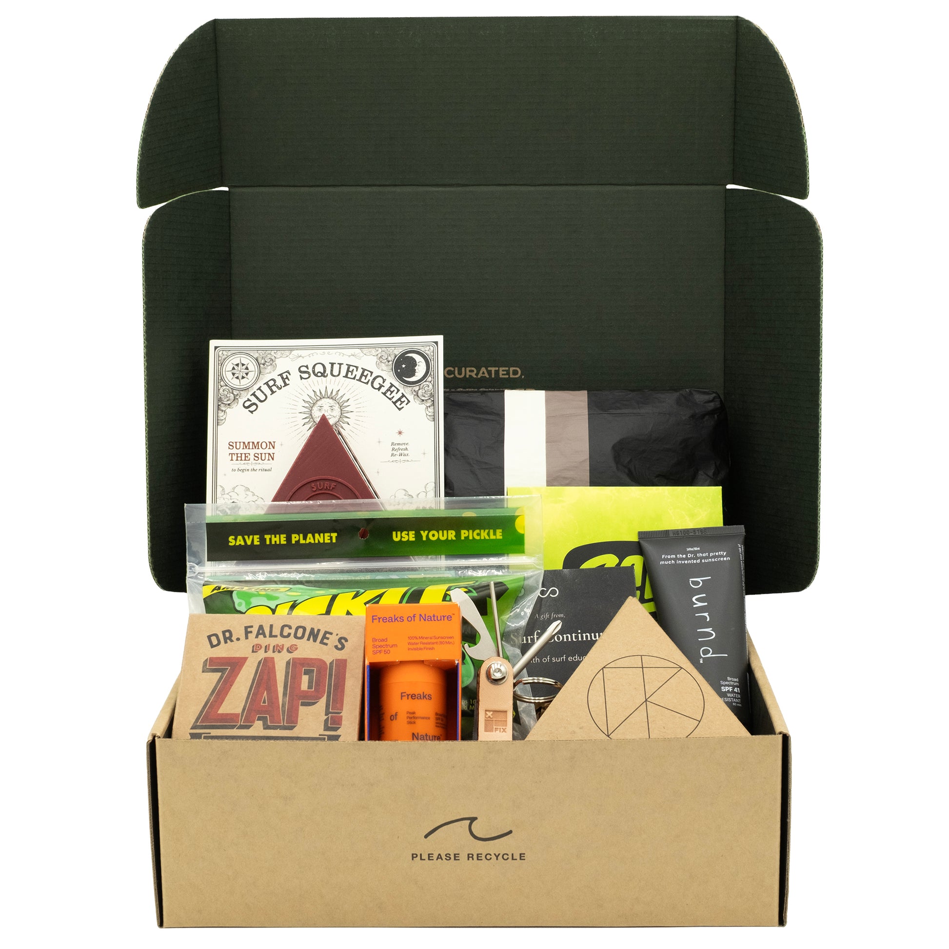 A curated beach or outdoor gift box set in a brown cardboard box with an open dark green lid, filled with various eco-friendly and travel-themed items including a surf squeeze box, a Dr. Falcone's ZAP! hand sanitizer, and other small packaged goods, on a white background.